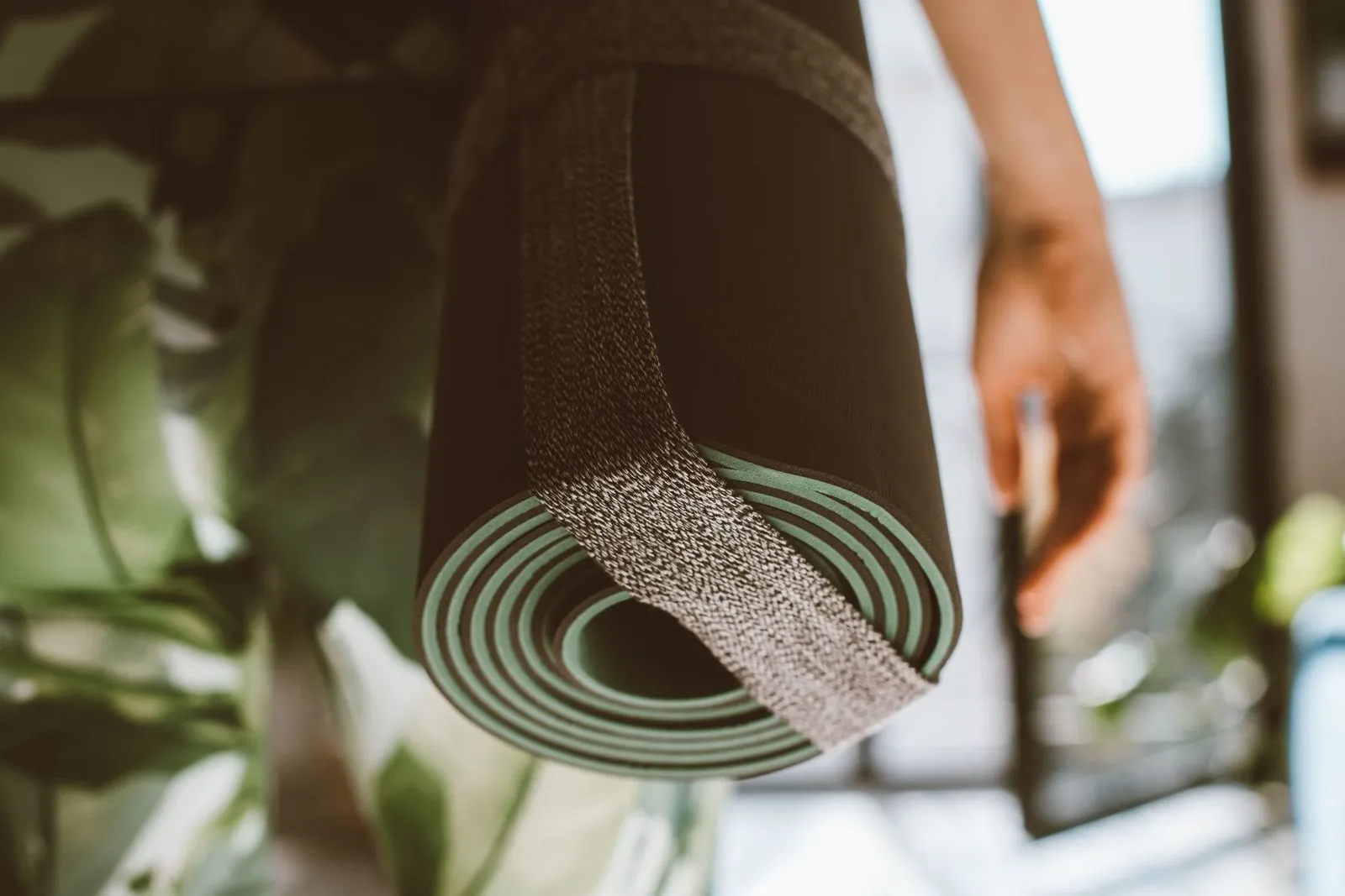 Plusieurs tapis de yoga déroulés côte à côte sur un parquet clair, aux épaisseurs et textures variées.